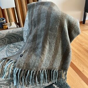 Warm throw. Gray blue with brown. Made by Shiraleah. 47% wool..
